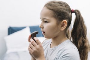 side-view-girl-using-asthma-inhaler-home